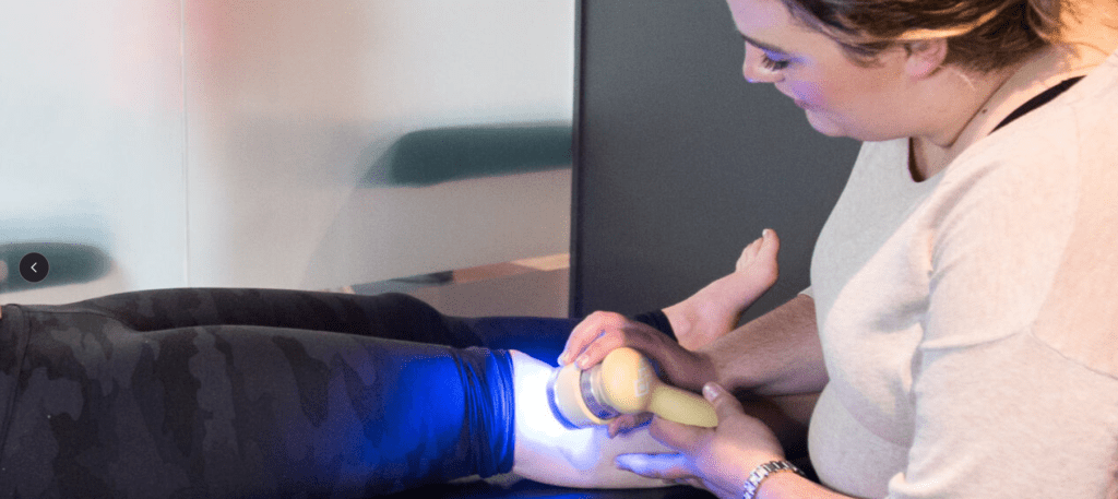 myo lab employee using laser therapy for arthritis