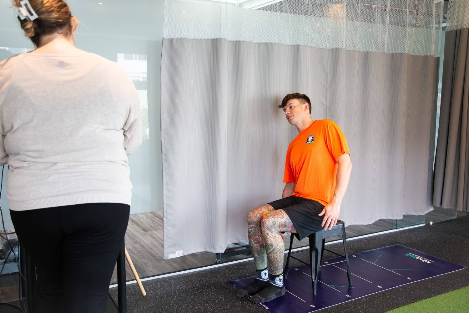 A client performing a movement exercise while being observed by a MYo Lab therapist.