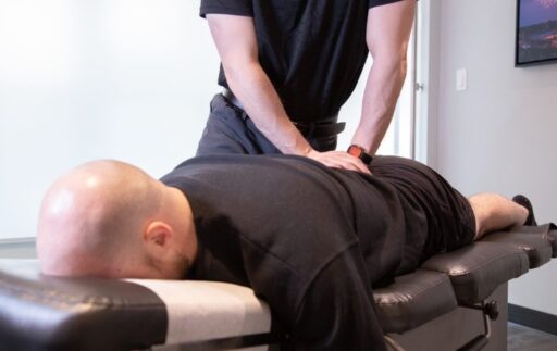 Chiropractor performing hands-on spinal manual therapy at MYo Lab Health & Wellness in Calgary.