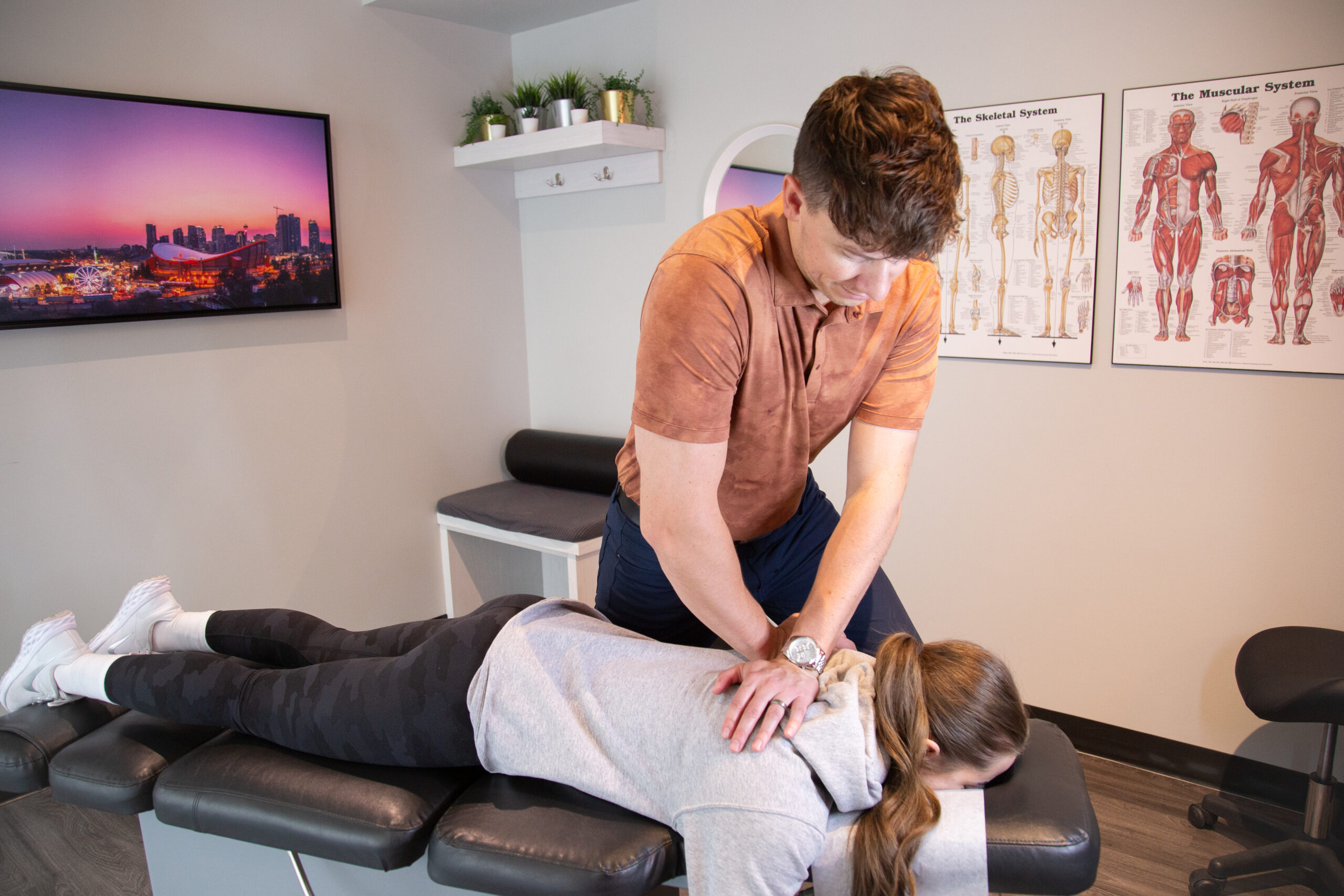 Chiropractor performing a spinal adjustment during treatment at MYo Lab Health & Wellness in Calgary.