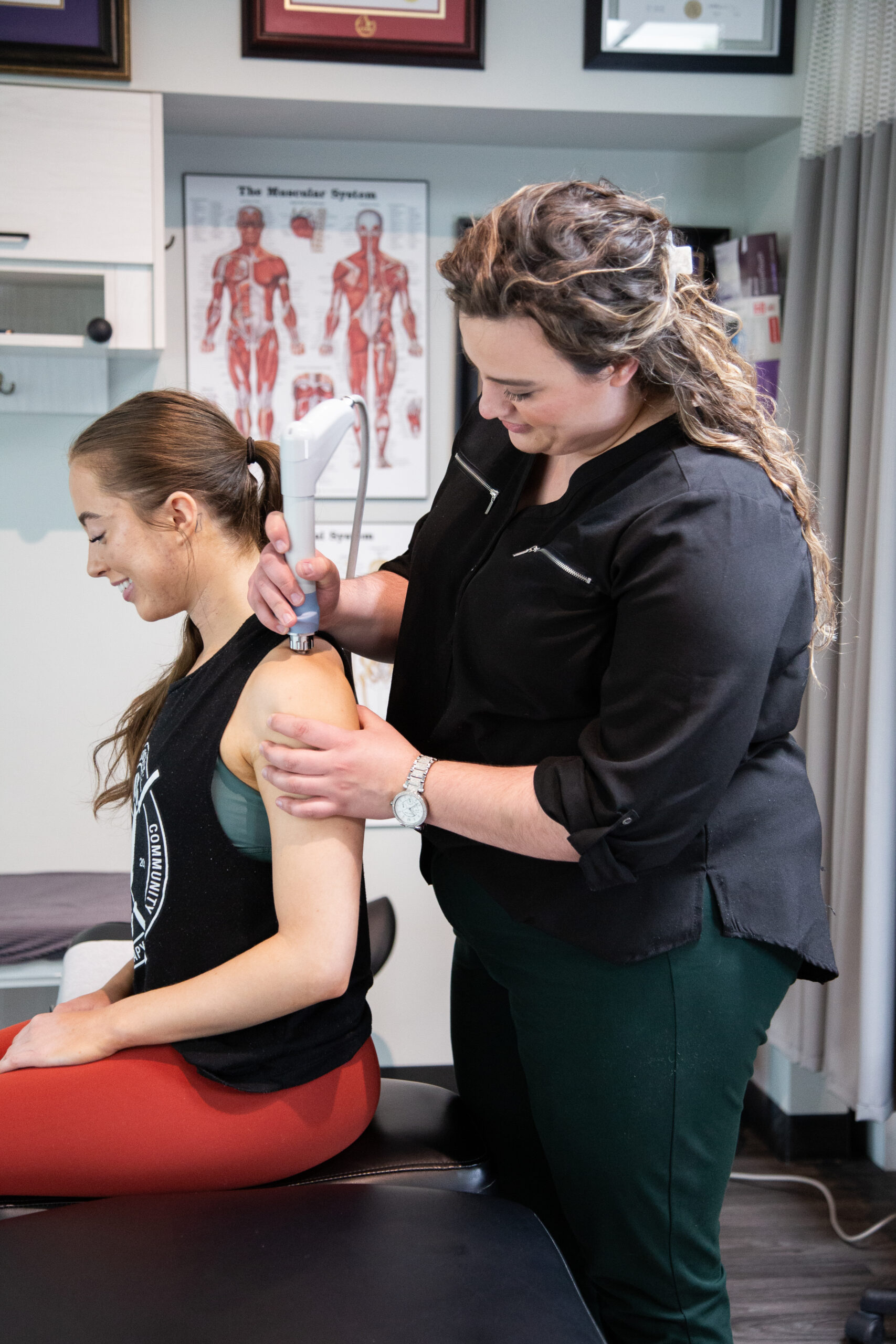 A MYo Lab, therapist applying low-level laser therapy to a member’s neck.