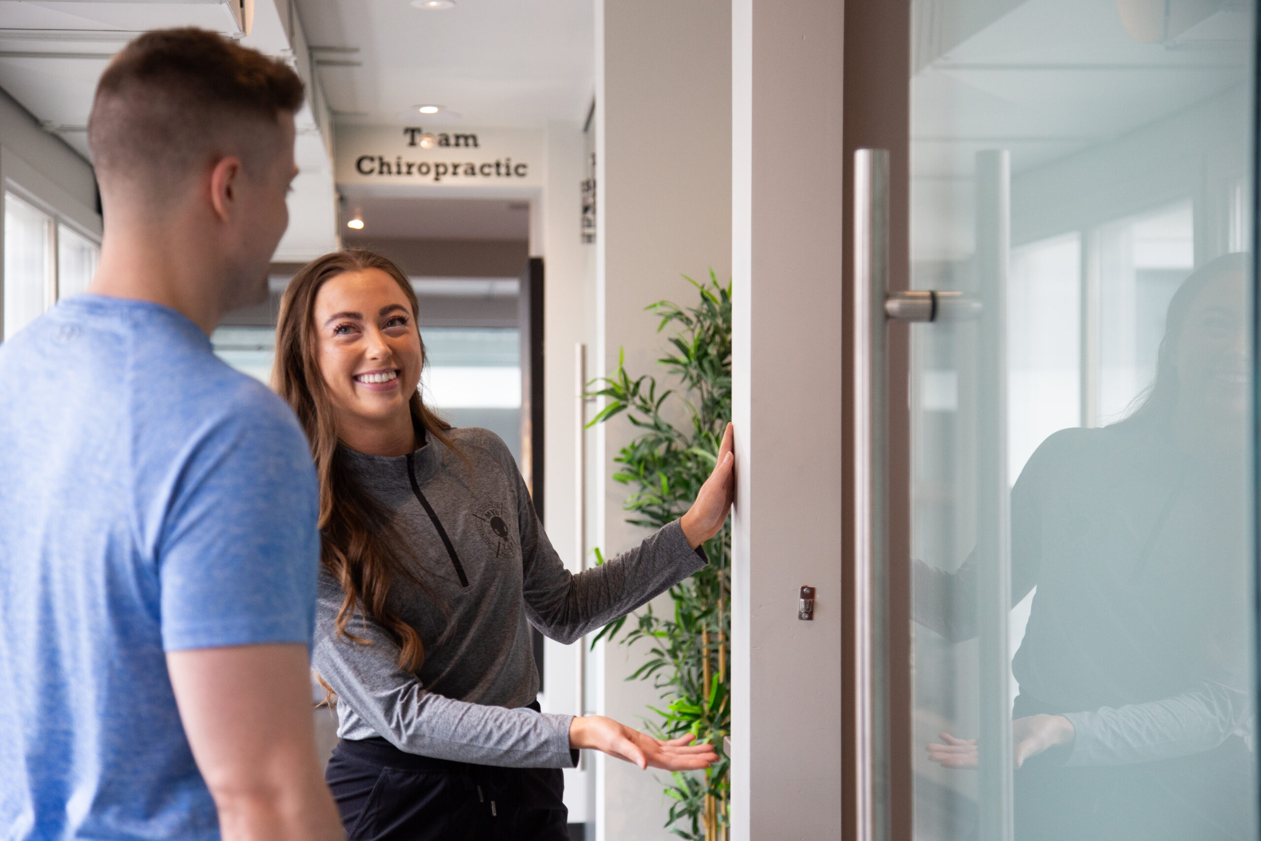 MYo Lab Health & Wellness team member welcoming a member into a private treatment room in Calgary.