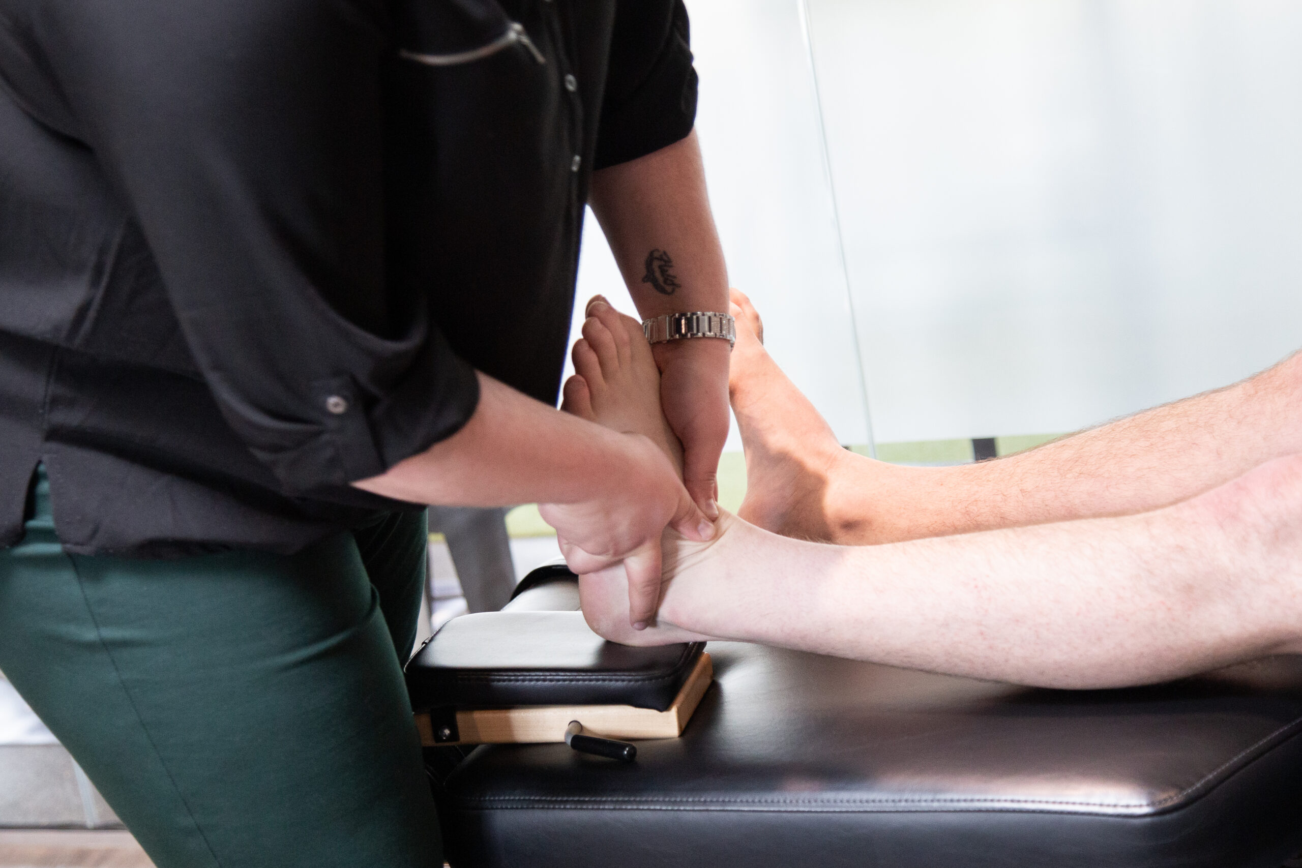 Clinician performing hands-on knee pain treatment to improve mobility and reduce discomfort.