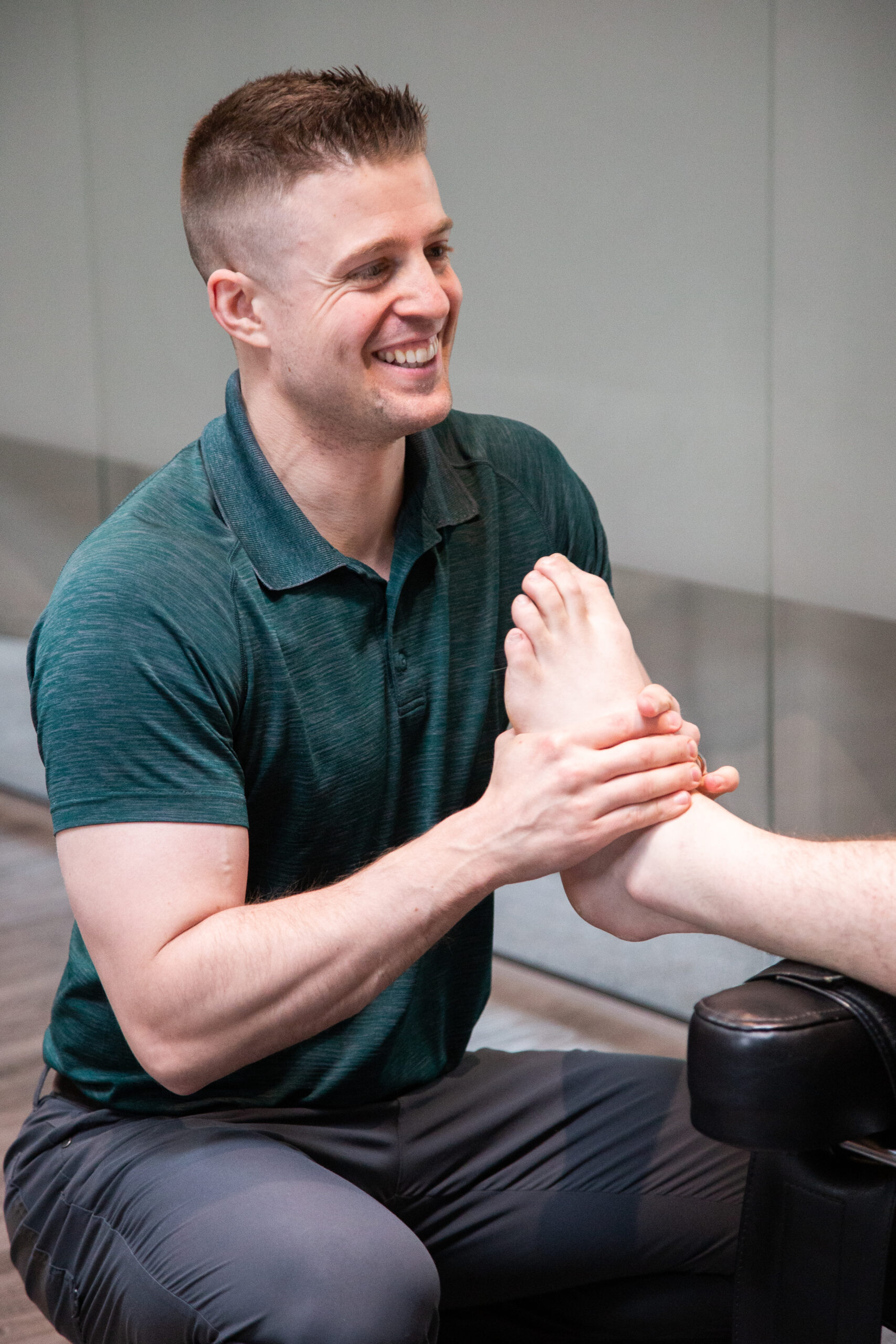Therapist providing manual therapy for ankle and foot pain during a treatment session at MYo Lab Health & Wellness in Calgary.