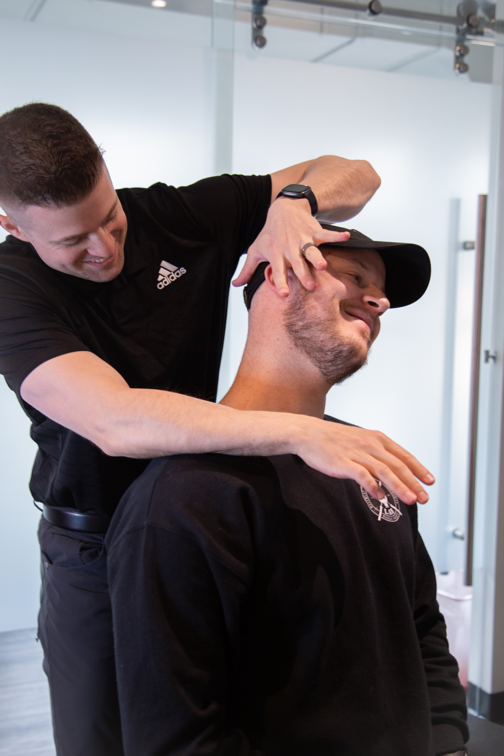 Chiropractor performing a neck adjustment to reduce pain, stiffness, and restore movement.