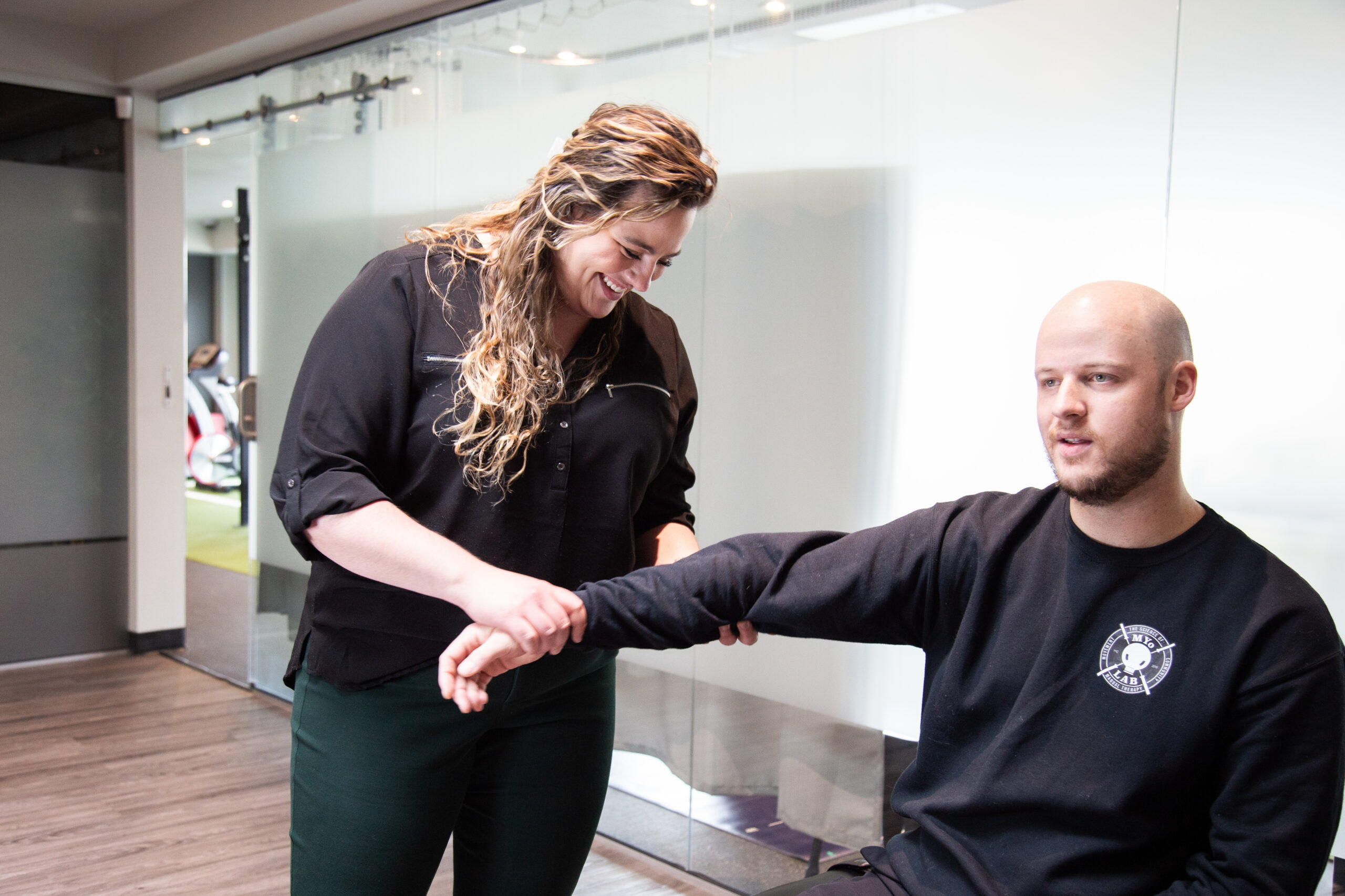 Therapist providing manual therapy for elbow and wrist pain at MYo Lab Health & Wellness in Calgary.