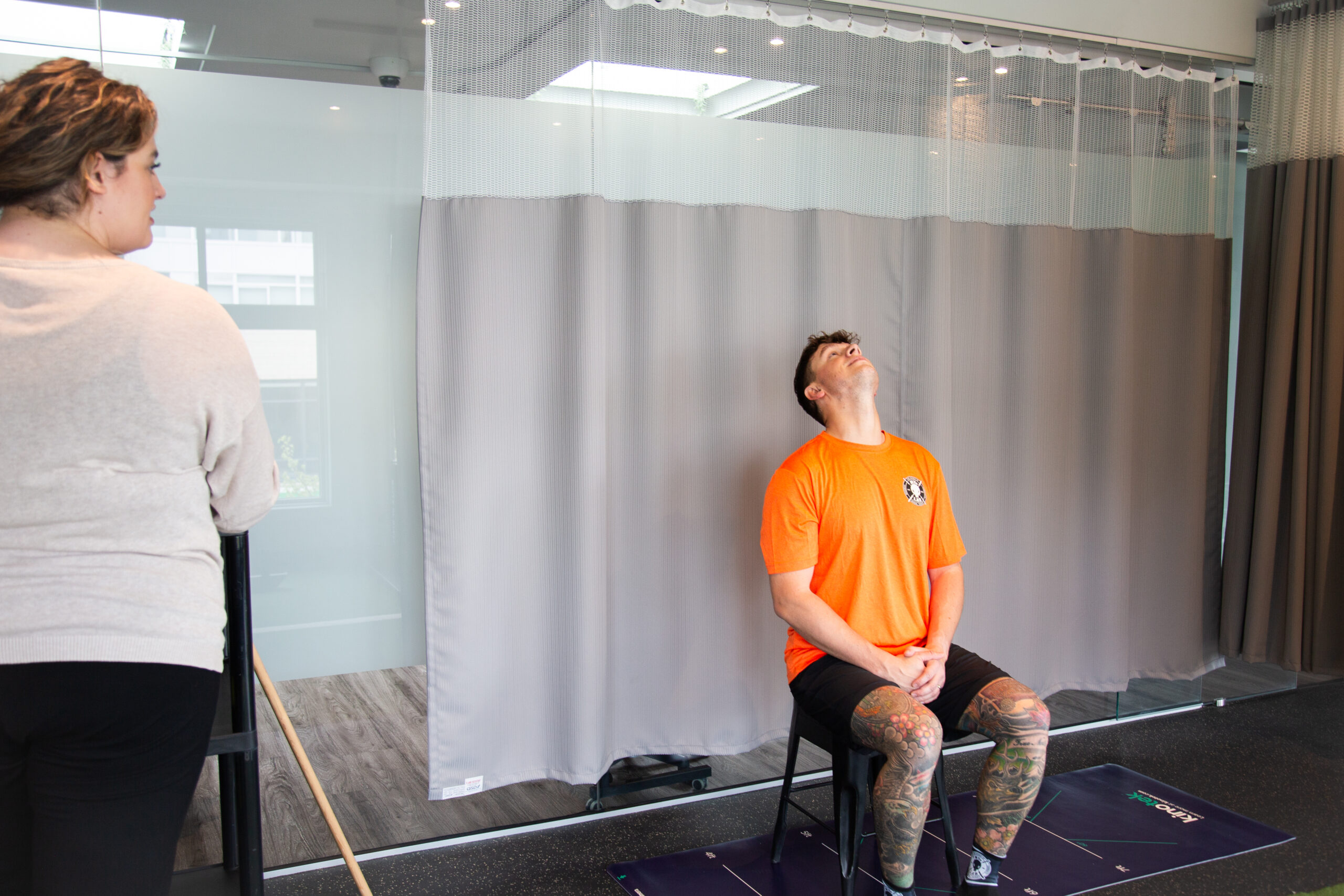 Member performing a neck movement assessment to evaluate mobility issues and neck pain as part of a clinical treatment plan.
