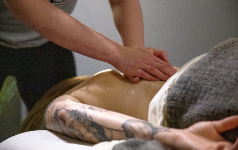 Relaxation massage being performed on the back to promote stress relief and comfort at MYo Lab Health & Wellness in Calgary.