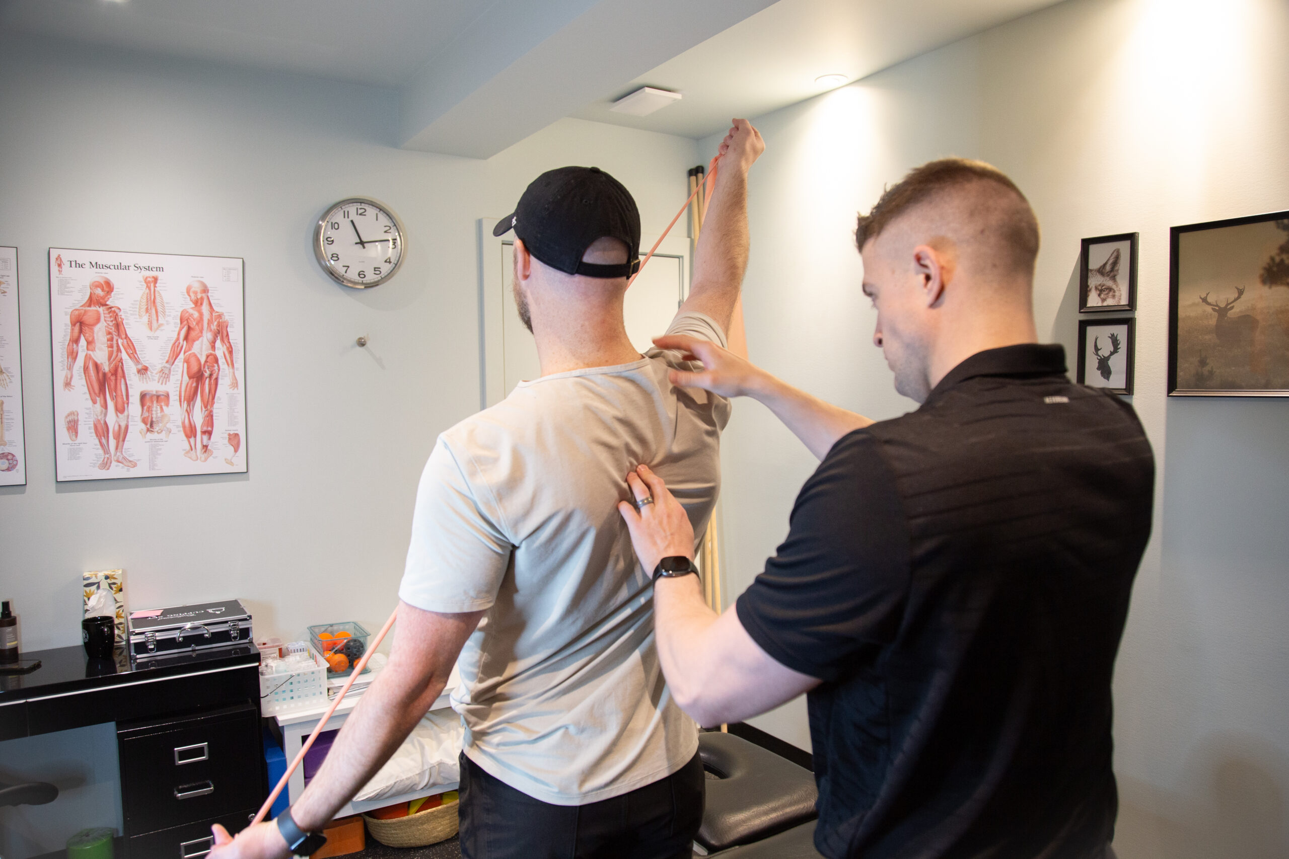 Physical therapist guiding shoulder mobility and stability during a hands-on shoulder pain treatment session.