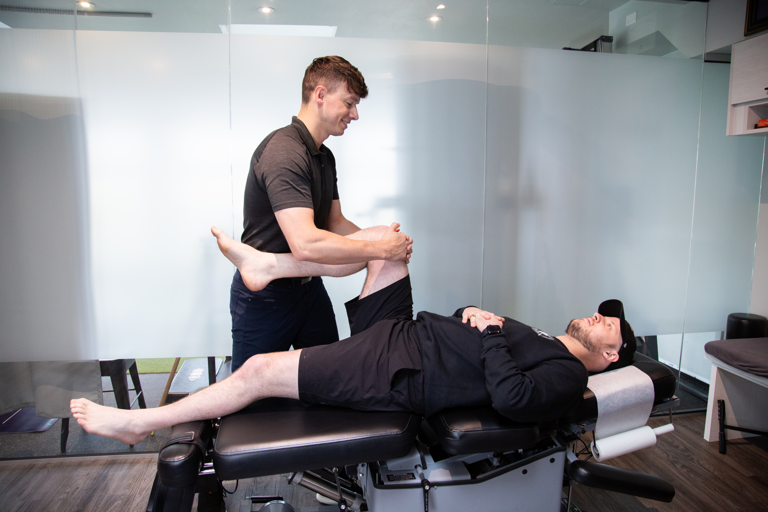 Therapist providing sports massage to support lower body mobility and recovery at MYo Lab Health & Wellness in Calgary.