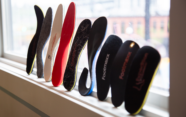 Selection of custom orthotic insoles designed to support foot alignment and biomechanics at MYo Lab Health & Wellness.